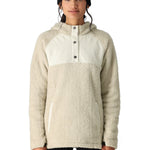 A woman wearing a cream-colored Sherpa fleece hoody with a button front and kangaroo pocket stands against a white background.