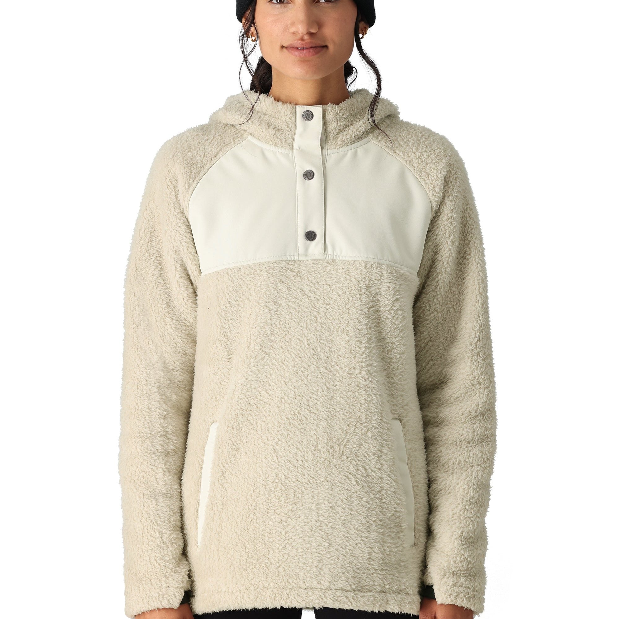 A woman wearing a cream-colored Sherpa fleece hoody with a button front and kangaroo pocket stands against a white background.