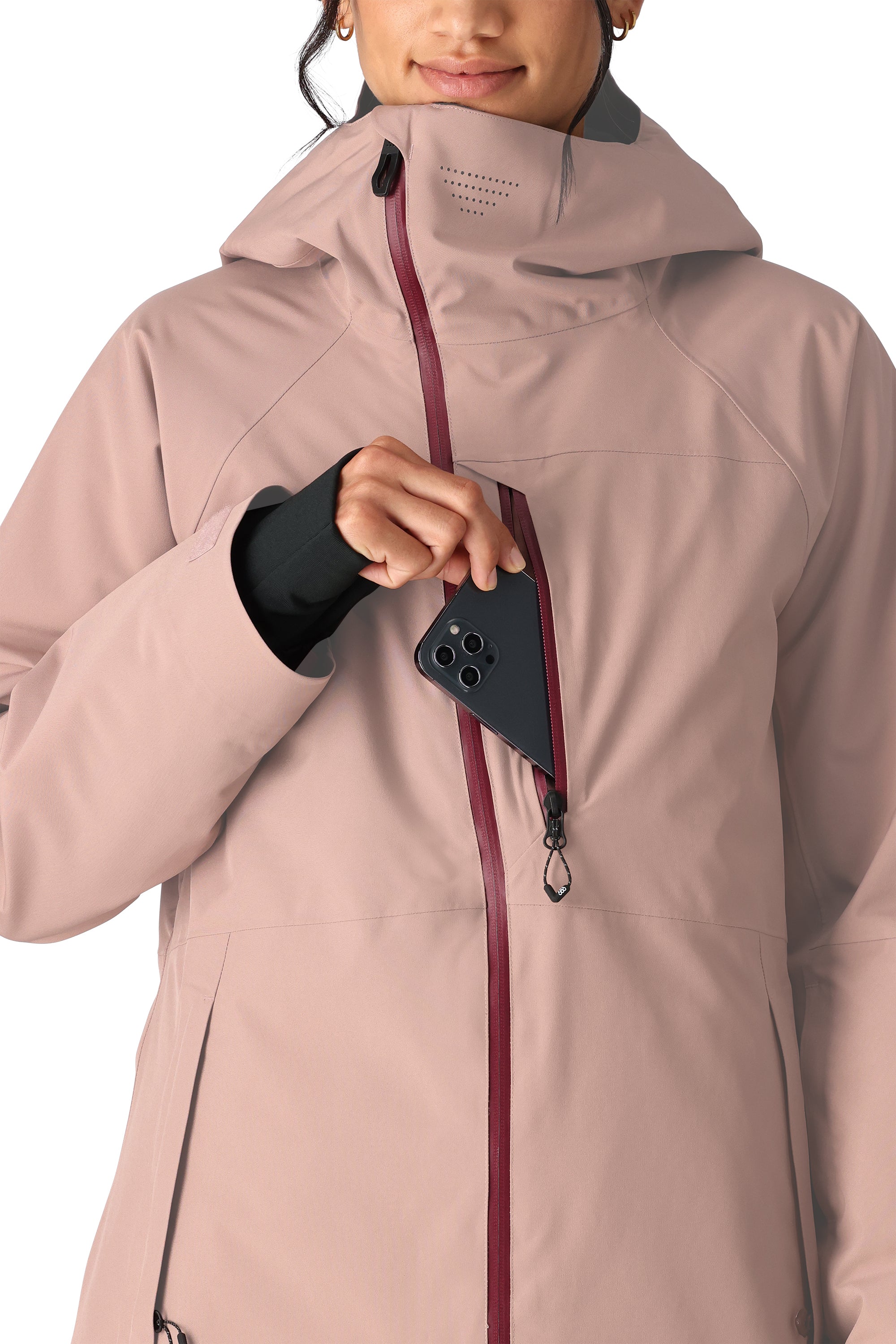The 686 Woman's Hydra Insulated Jacket 2025 features a light pink color with a burgundy zipper and is shown in a front view.