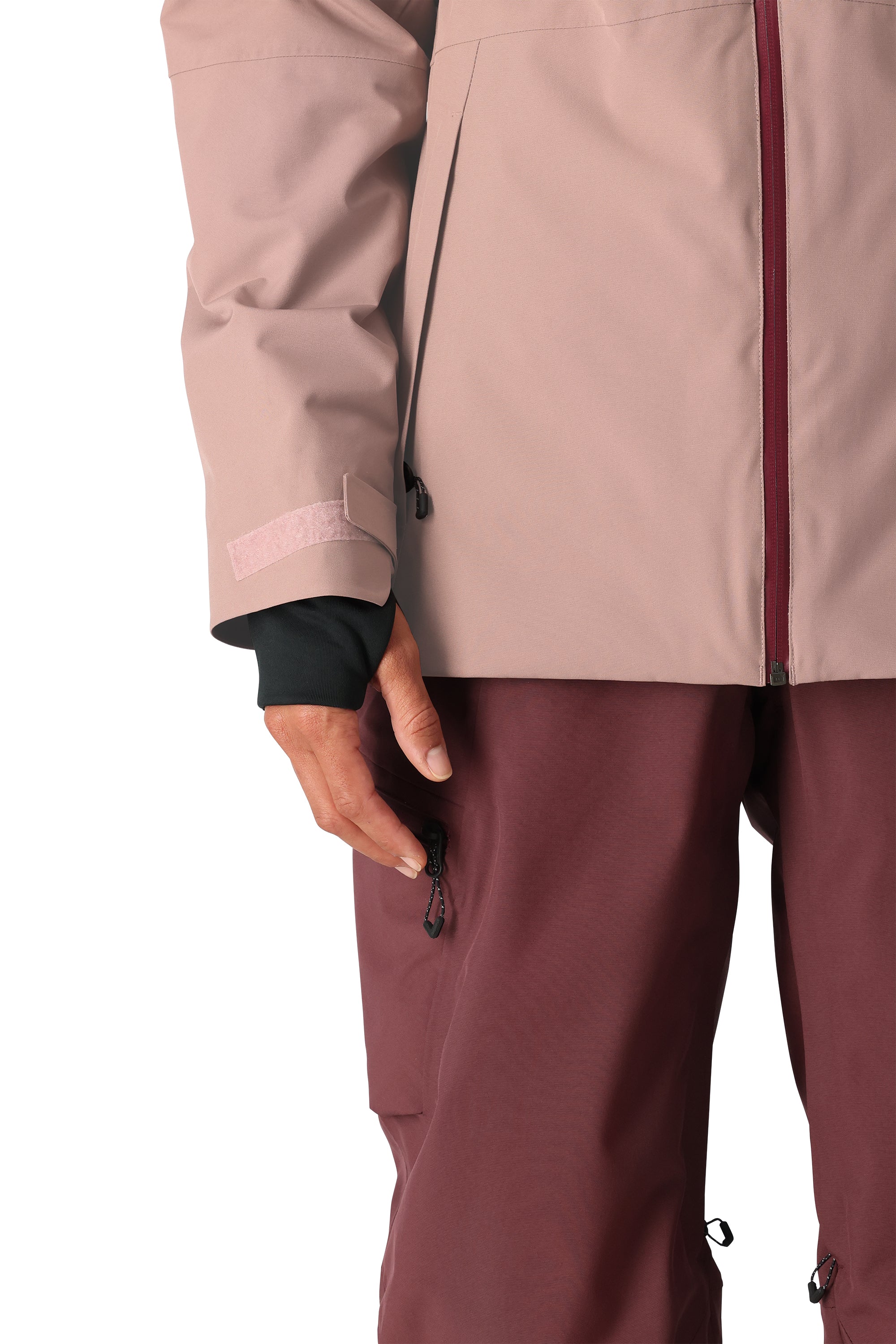 The 686 Woman's Hydra Insulated Jacket 2025 is primarily light pink with a black zipper and appears to have an insulated hood.