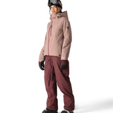 The 686 Woman's Hydra Insulated Jacket 2025 is primarily tan with a red zipper and has a hood.