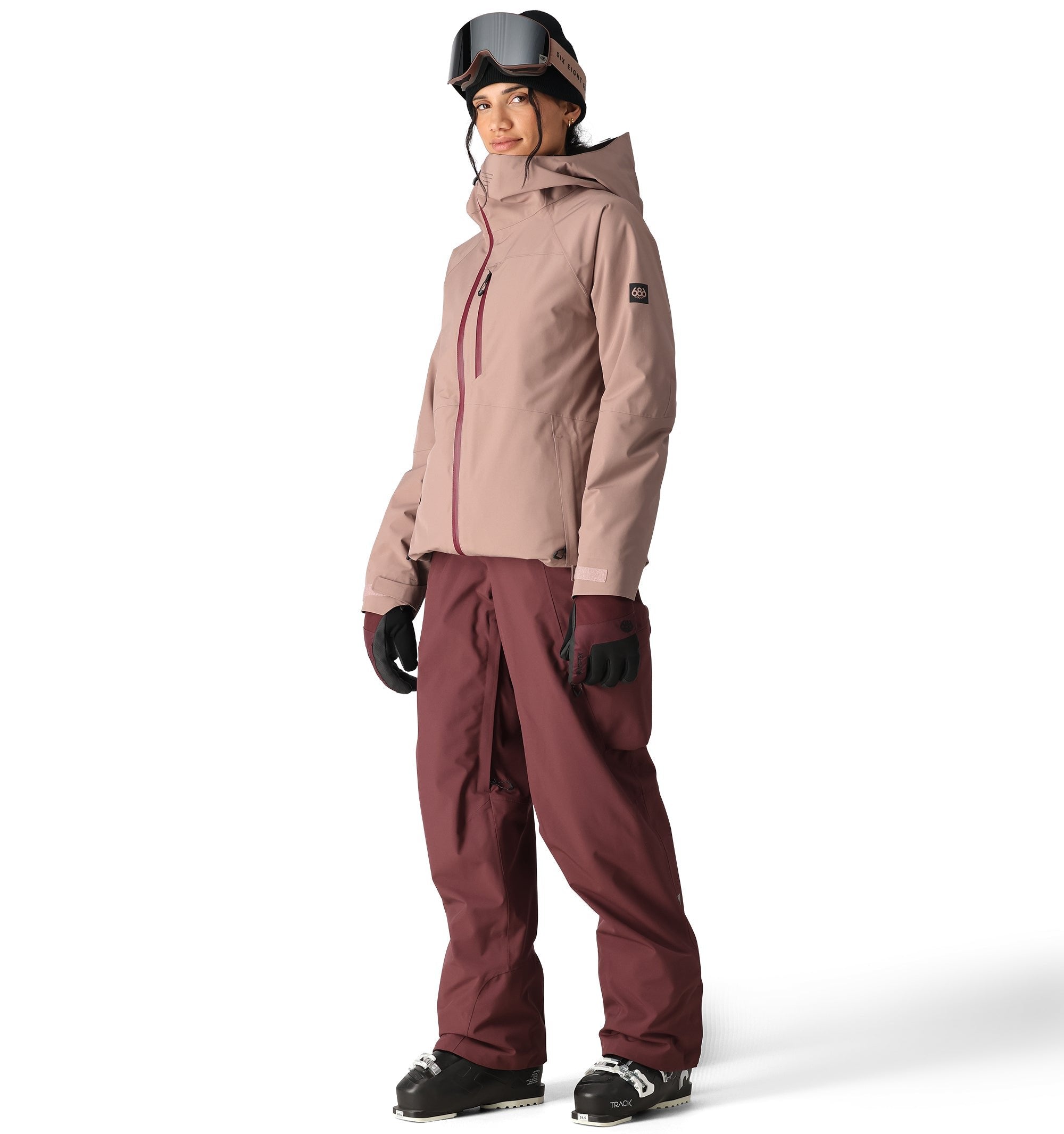 The 686 Woman's Hydra Insulated Jacket 2025 is primarily tan with a red zipper and has a hood.