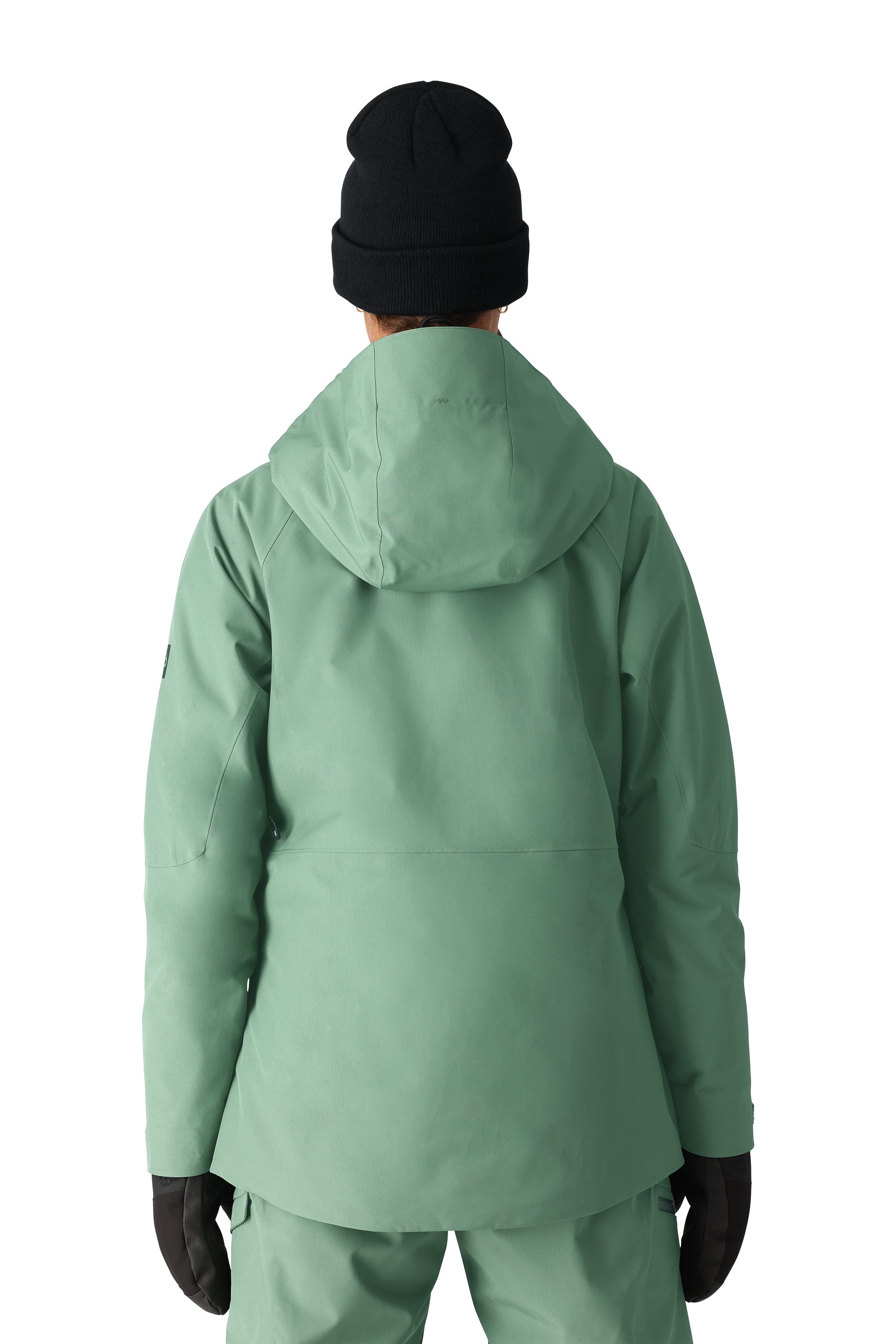 The 686 Woman's Hydra Insulated Jacket 2025 is primarily a sage green color with black accents on the sleeve and zippered pockets.
