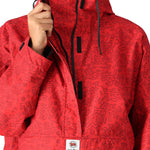 The 686 Women's Outline Shell Anorak 2025 is primarily red with black accents and has a hood.