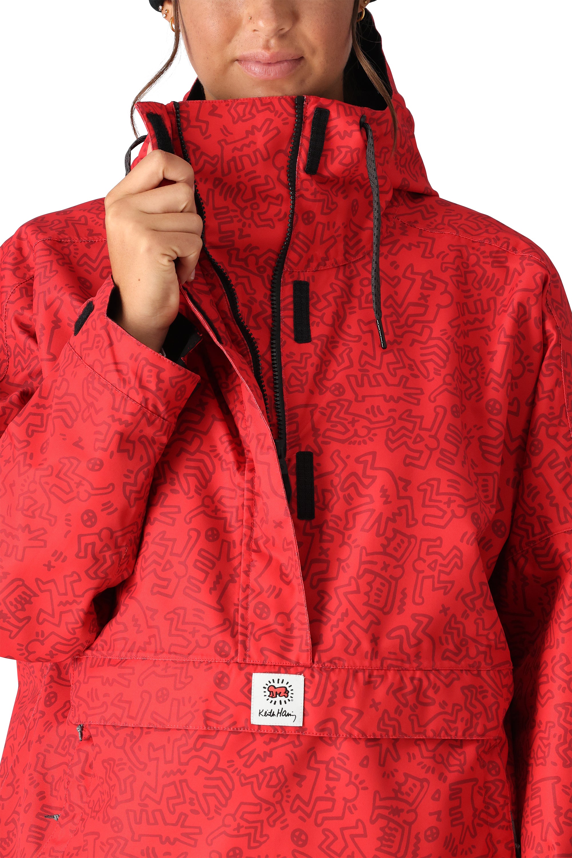 The 686 Women's Outline Shell Anorak 2025 is primarily red with black accents and has a hood.