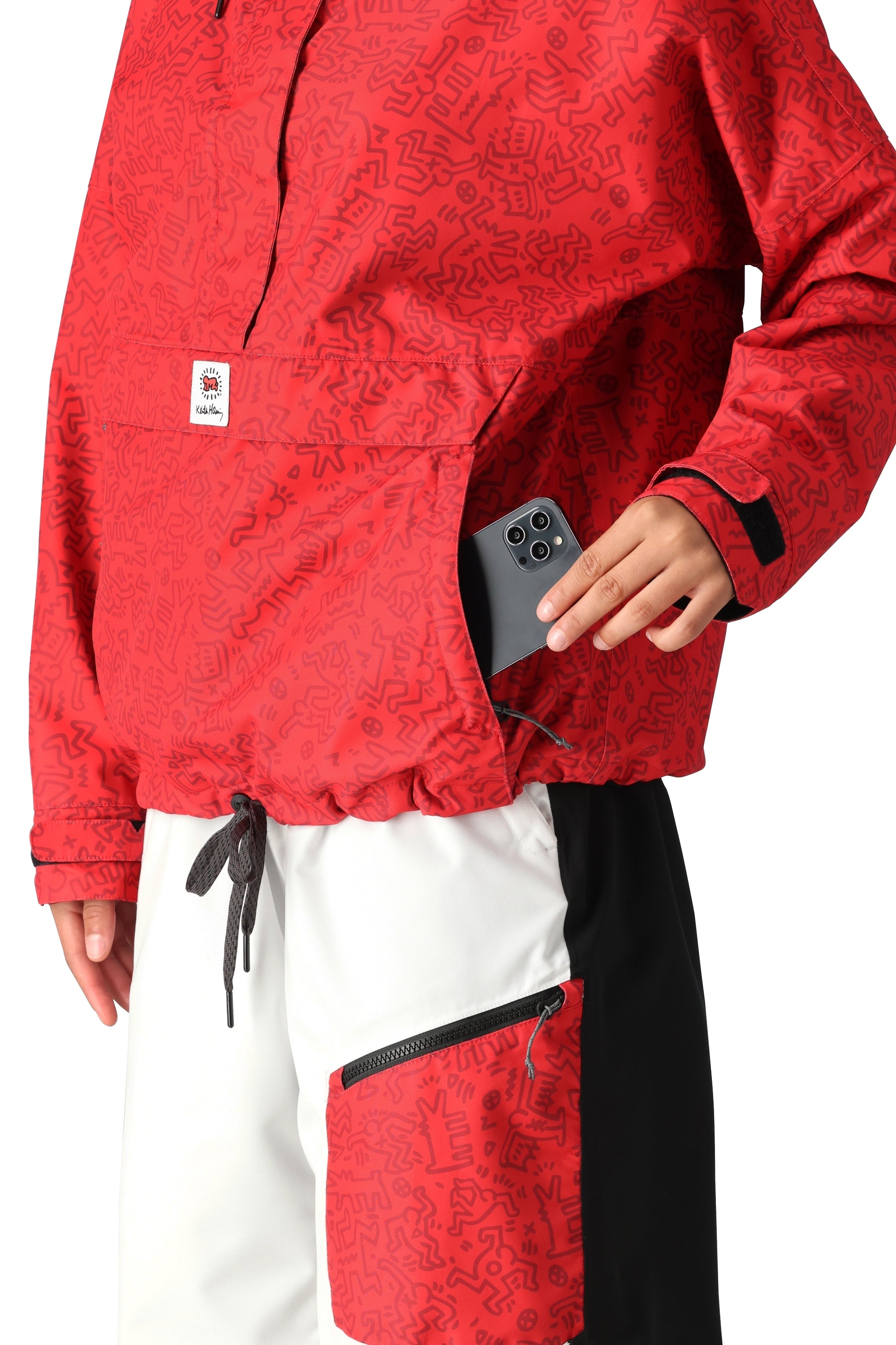 The 686 Women's Outline Shell Anorak jacket has a red exterior with black accents and a white logo on the left chest.