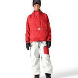 The 686 women's Outline Shell Anorak has a red and black patterned shell with a high collar and zippered pockets on either side.