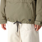 The 686 Women's Outline Shell Anorak 2025 jacket is olive green with an insulated hood and drawstring waist.