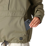 The 686 Women's Outline Shell Anorak in olive green features an insulated hood and a front zip closure.