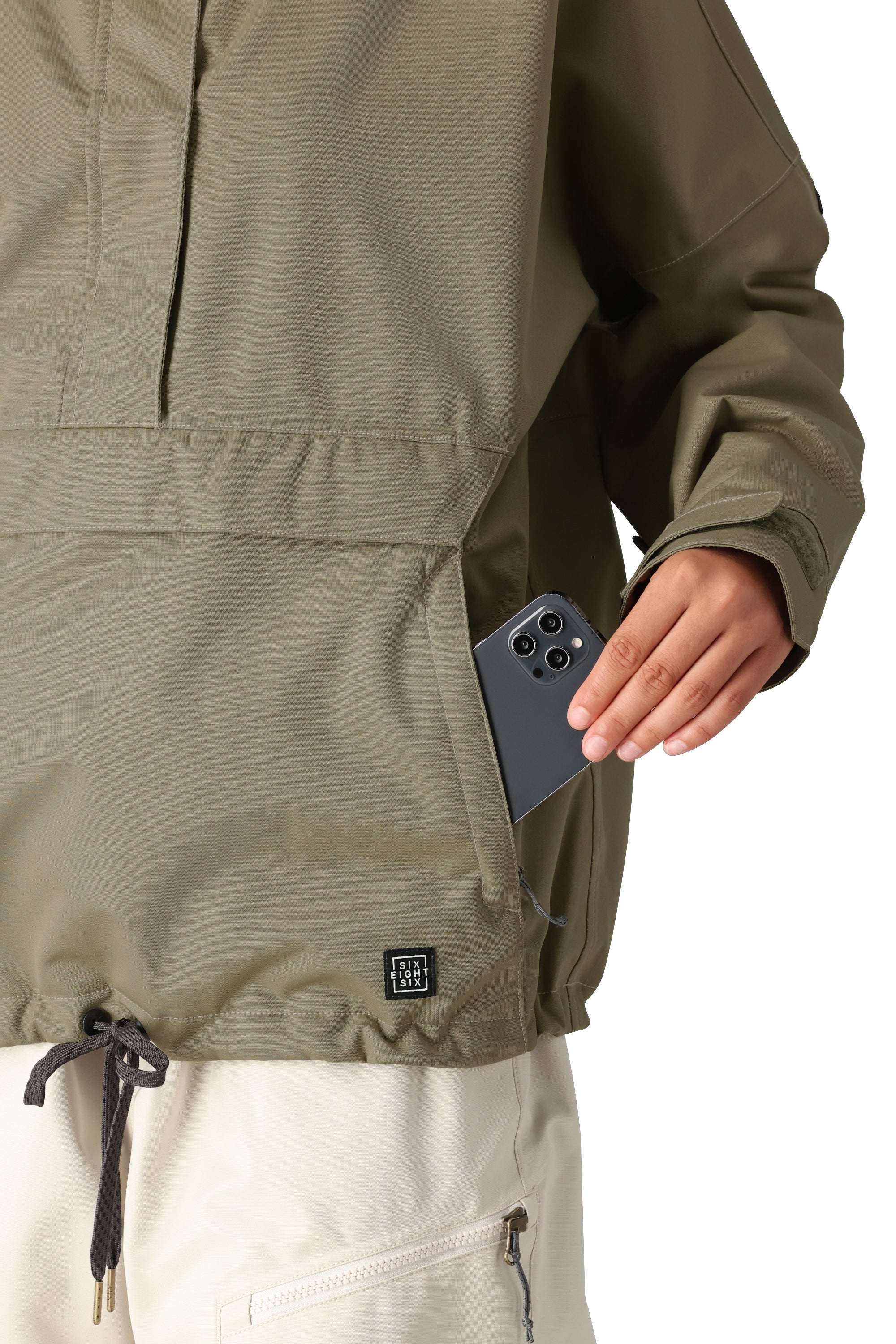 The 686 Women's Outline Shell Anorak in olive green features an insulated hood and a front zip closure.