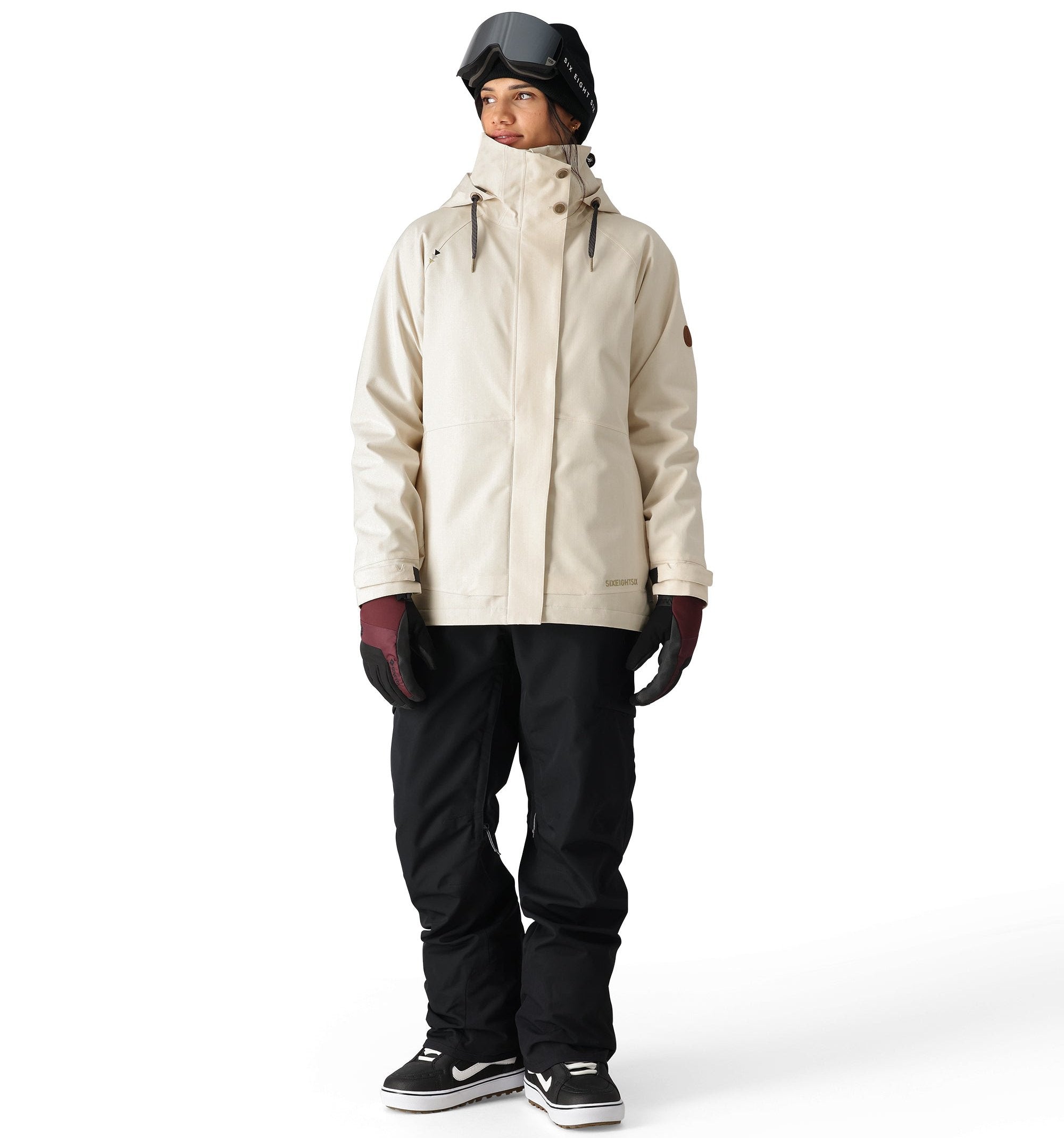 The 686 Women's SMARTY 3-in-1 Spellbound Jacket in cream features a high collar and zippered pockets.