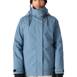 The 686 Women's SMARTY 3-in-1 Spellbound Jacket in blue has a high collar and an insulated hood.