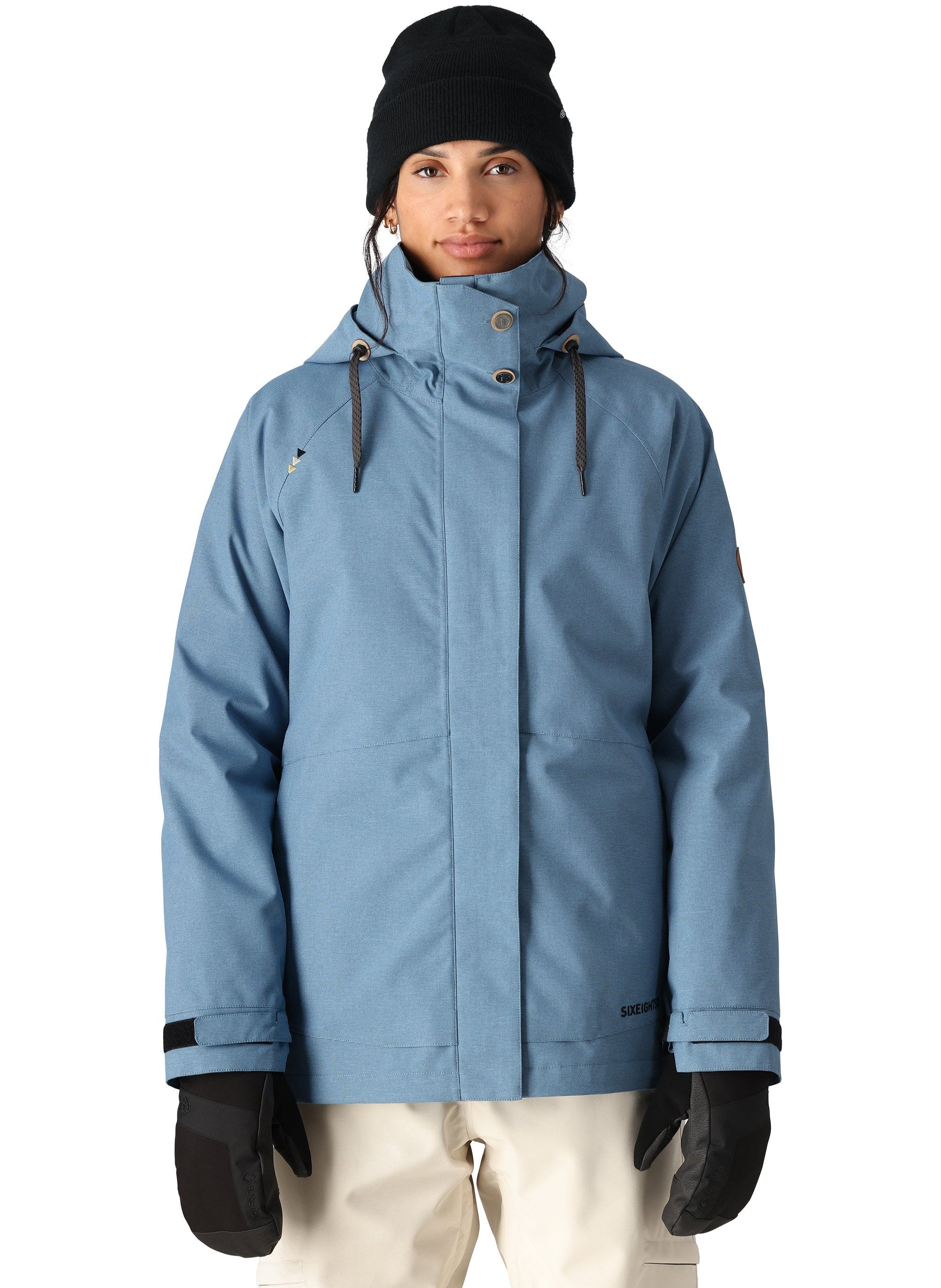 The 686 Women's SMARTY 3-in-1 Spellbound Jacket in blue has a high collar and an insulated hood.