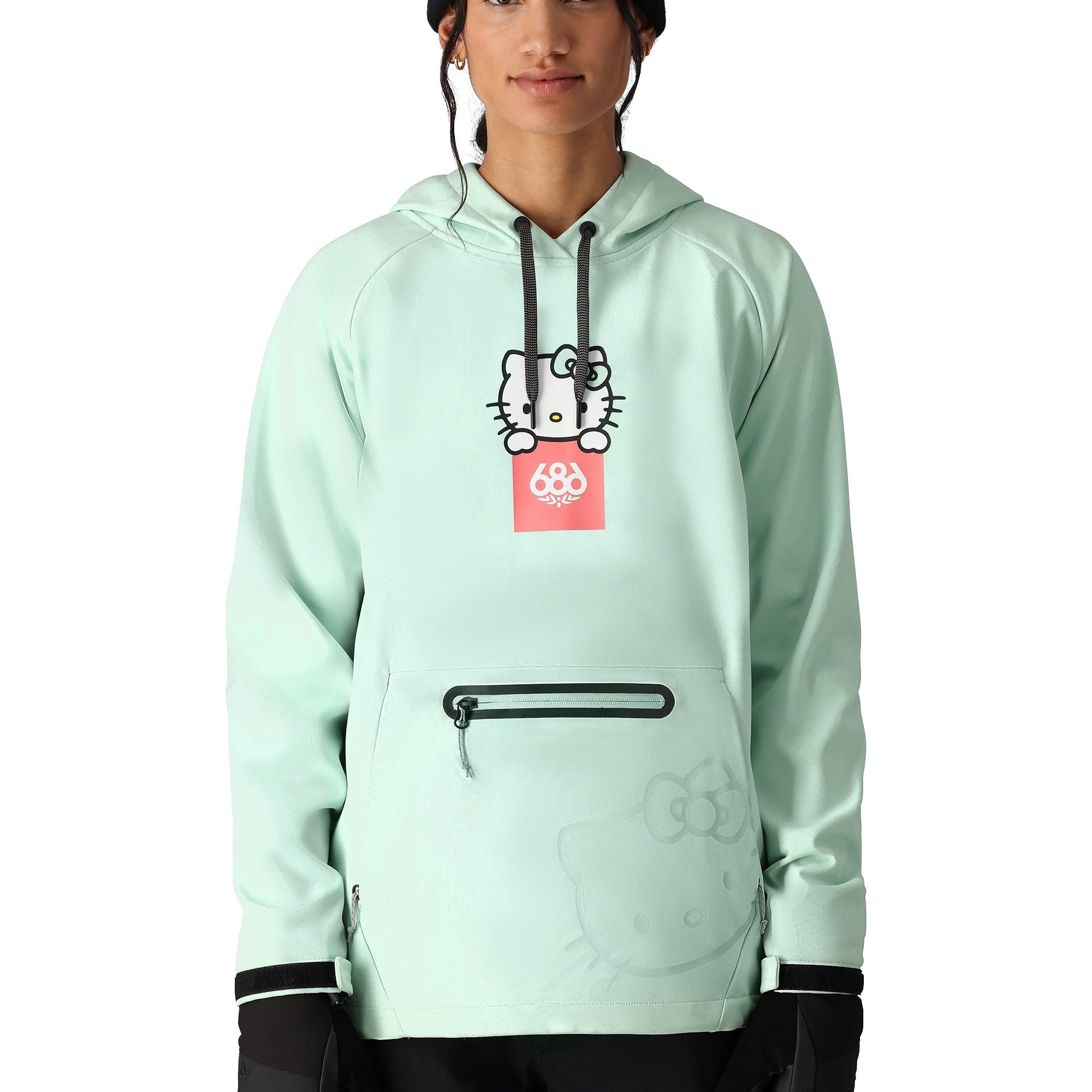 The 686 Women's Waterproof Hoody 2025 in this front view is light mint green with black accents and a Hello Kitty graphic on the chest.