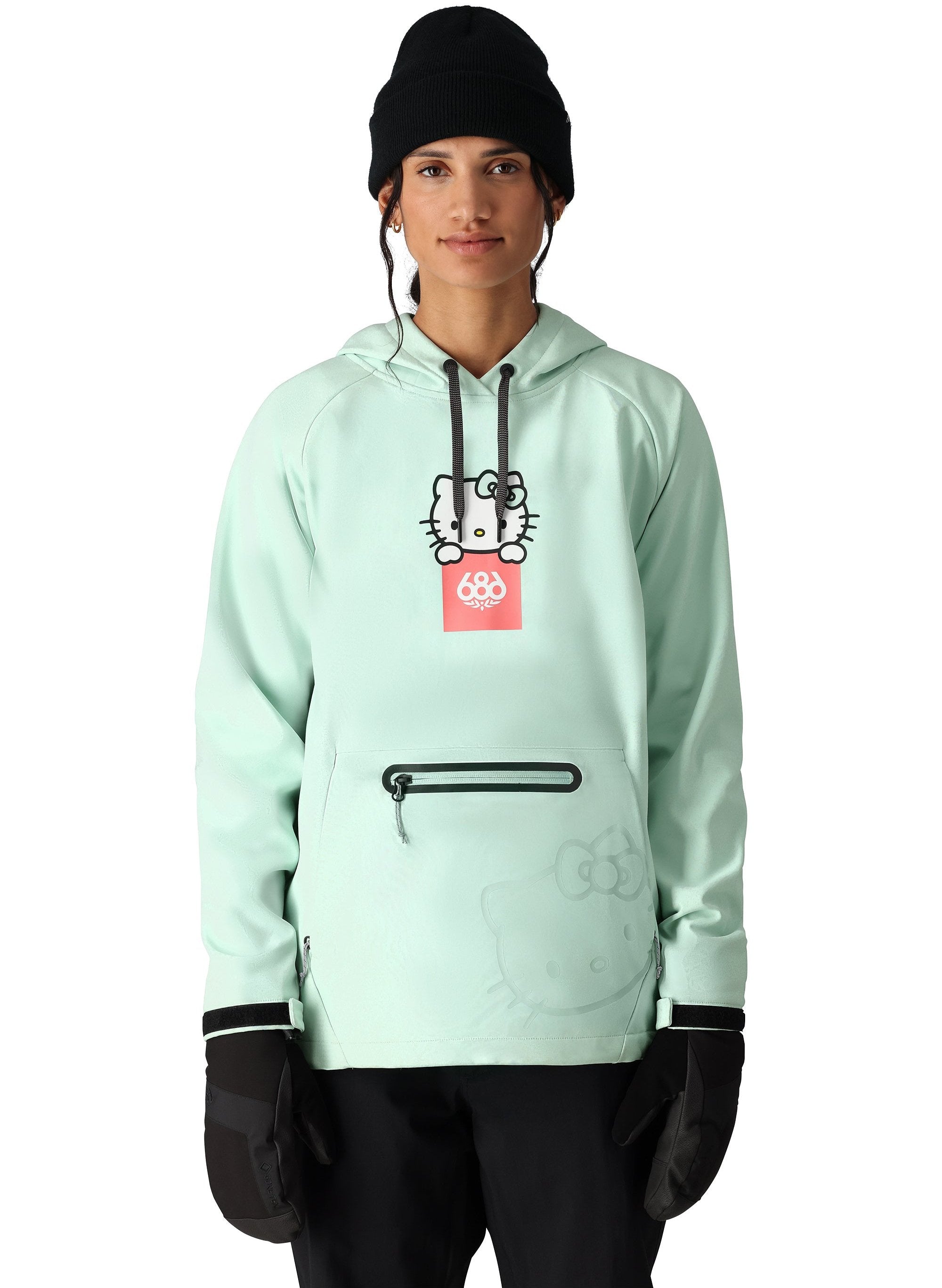The 686 Women's Waterproof Hoody 2025 in this front view is light mint green with black accents and a Hello Kitty graphic on the chest.