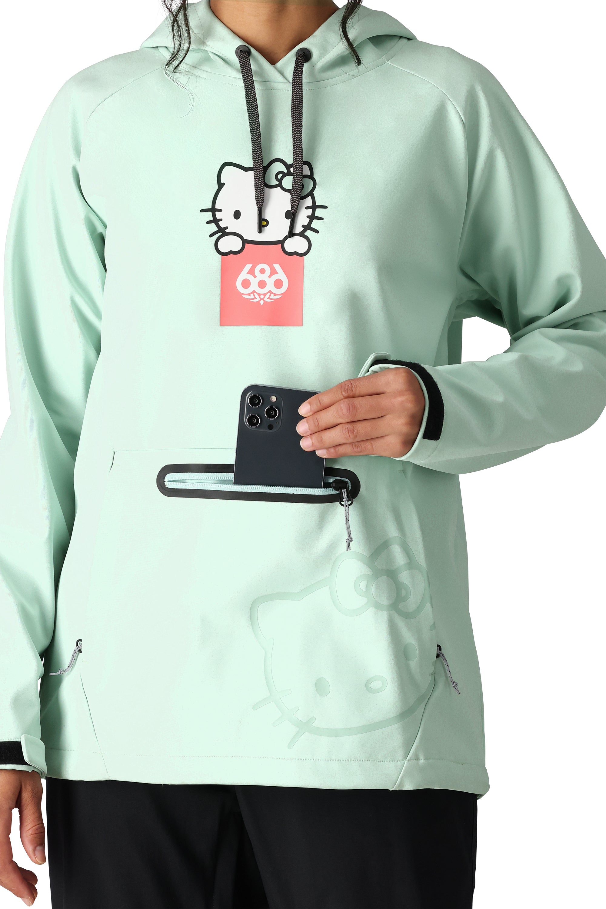 The 686 Women's Waterproof Hoody 2025 in light green has a black drawstring and a large front zipper pocket.