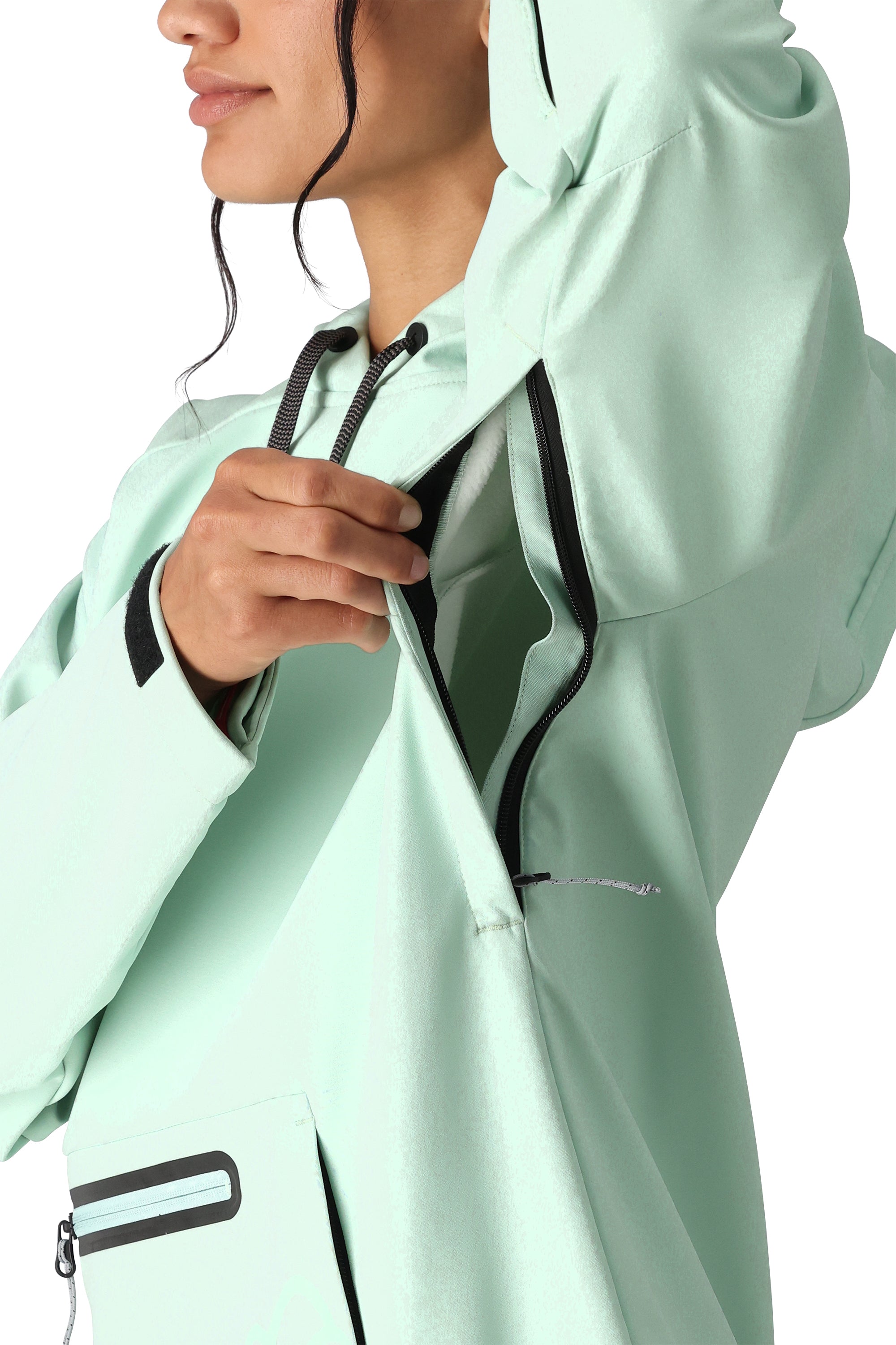 The 686 Women's Waterproof Hoody 2025 in mint green showcases a black zipper and drawstring on its front.