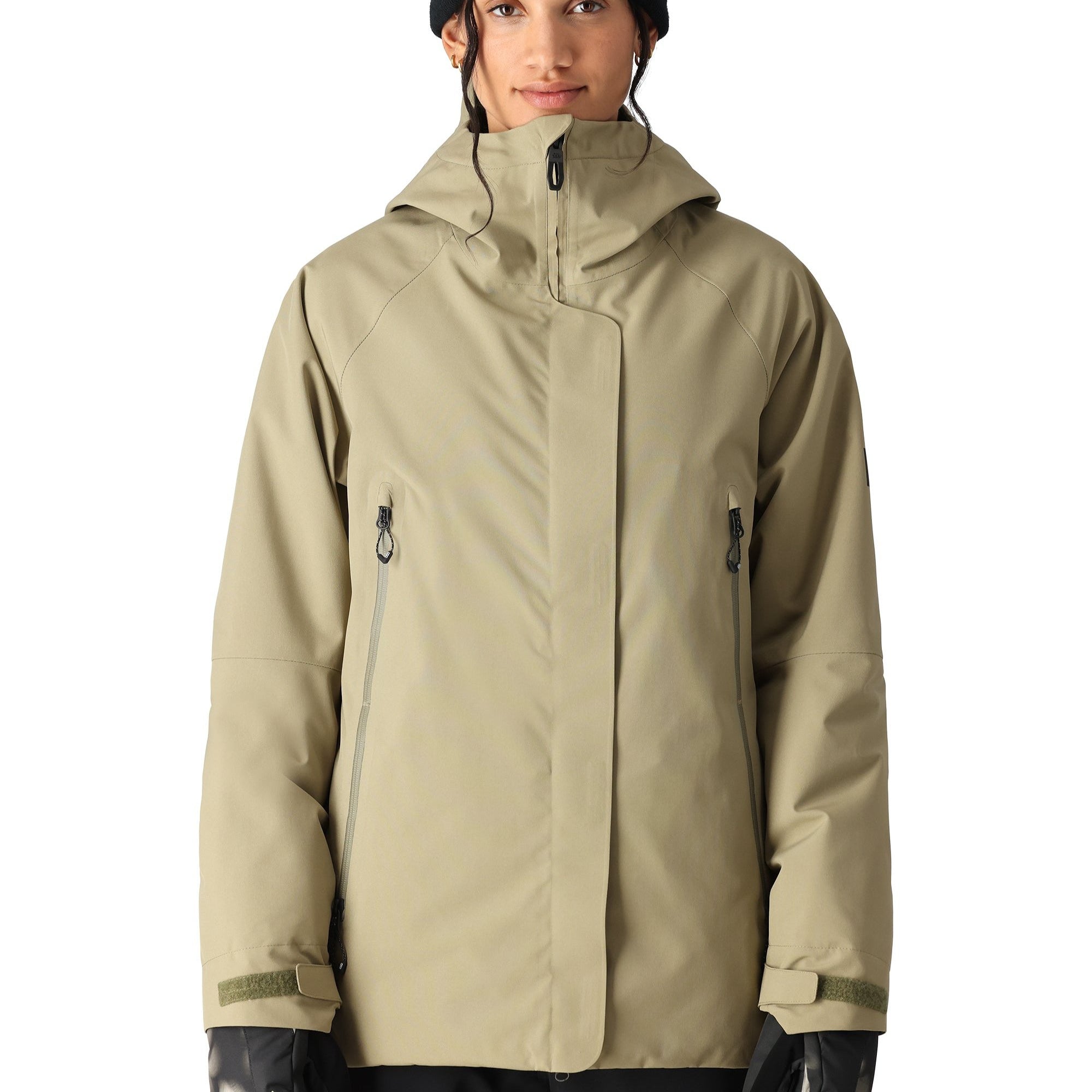 The 686 Whisper Insulated Jacket in tan has a high collar and zippered pockets.