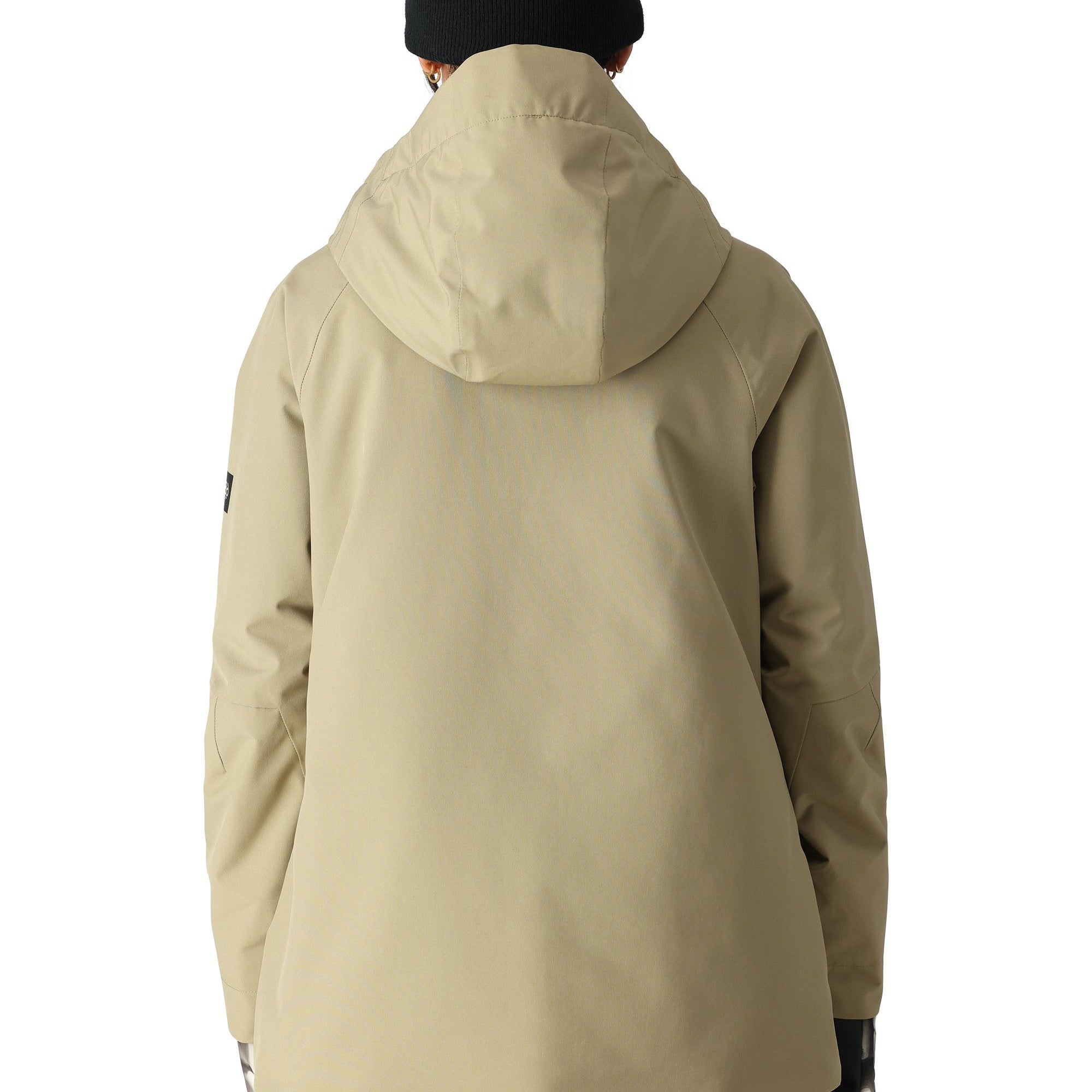 The 686 Whisper Insulated Jacket 2025 is primarily tan with black accents on the front zipper and left sleeve.
