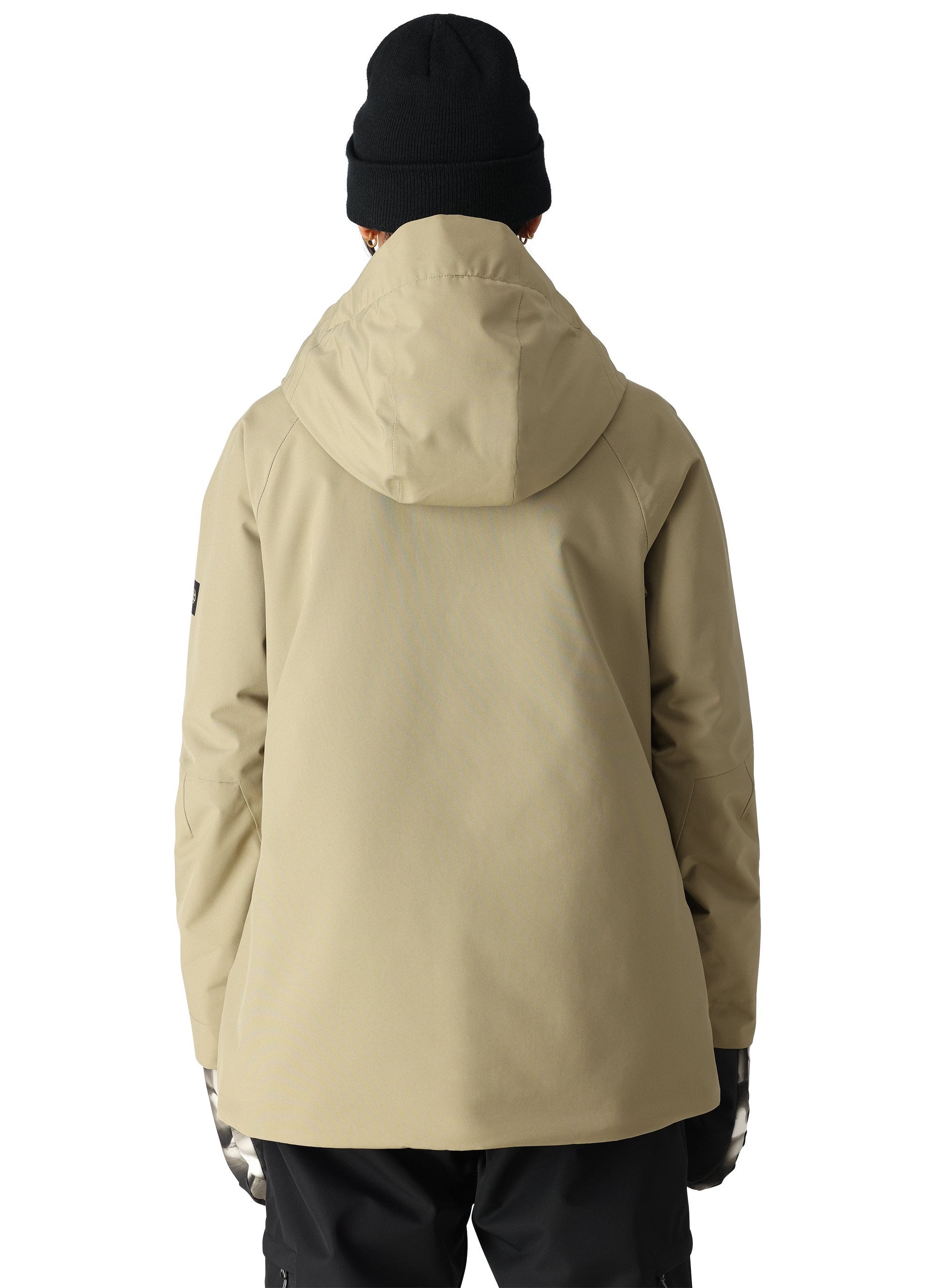 The 686 Whisper Insulated Jacket 2025 is primarily tan with black accents on the front zipper and left sleeve.