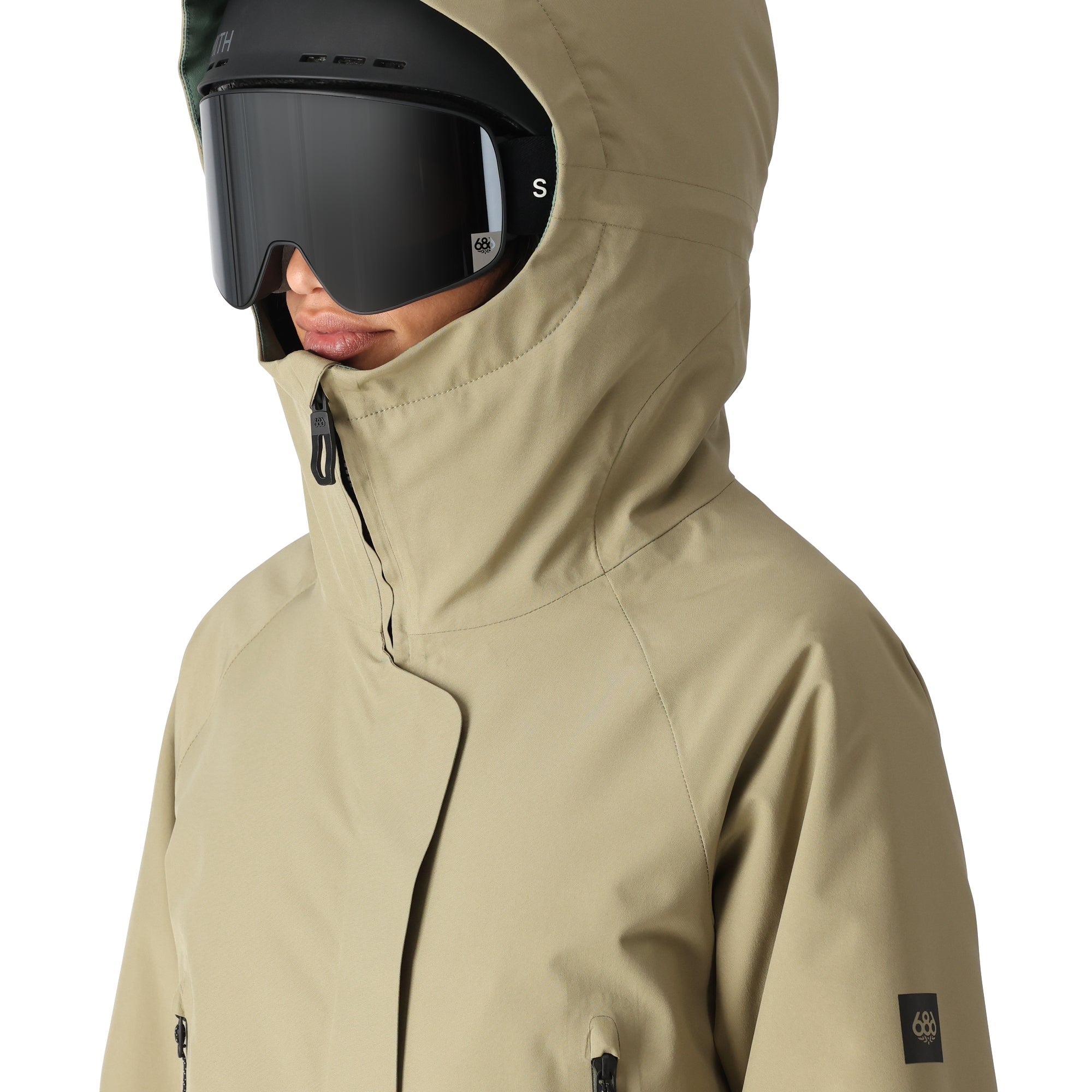 The 686 Whisper Insulated Jacket in khaki has an oversized hood and zippered pockets.
