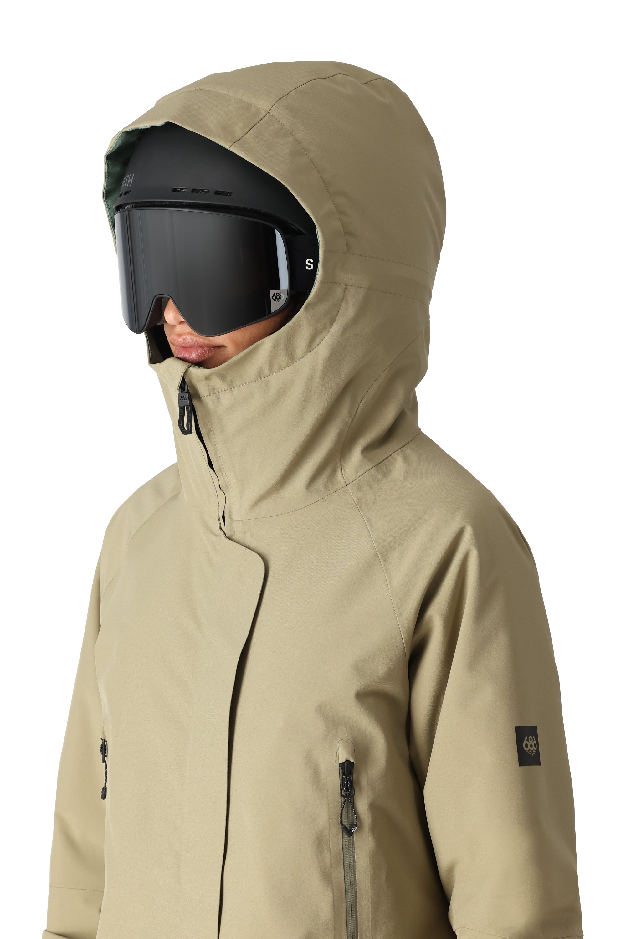The 686 Whisper Insulated Jacket in khaki has an oversized hood and zippered pockets.