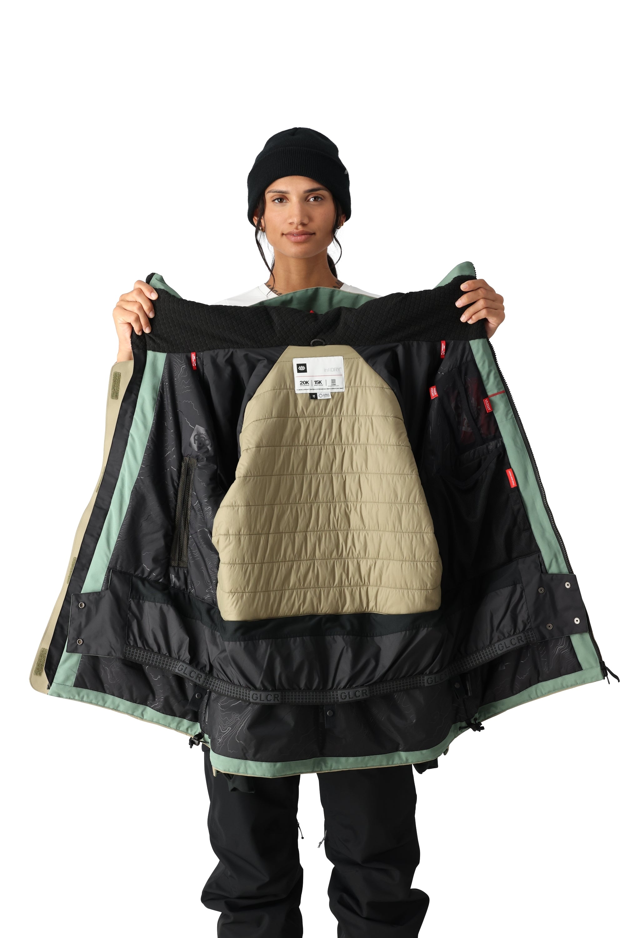 The 686 Women's Whisper Insulated Jacket 2025 is primarily black with sage green accents and an insulated hood.