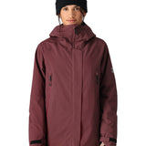 The 686 Whisper Insulated Jacket is primarily burgundy with black accents and a large collar.