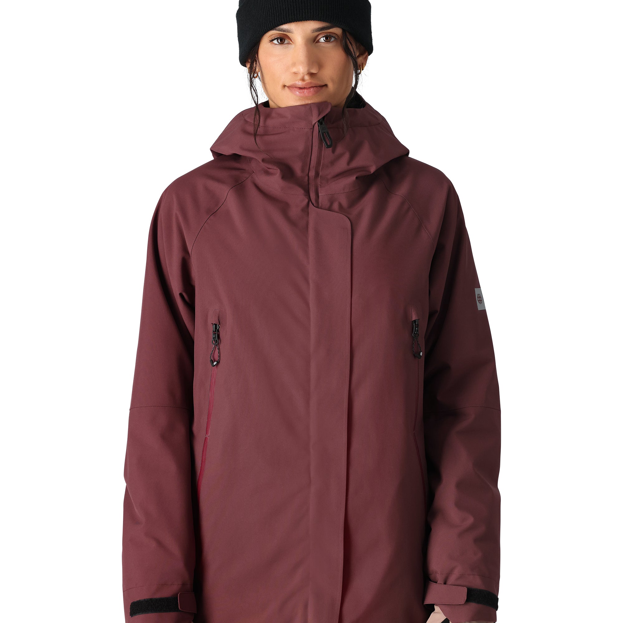 The 686 Whisper Insulated Jacket is primarily burgundy with black accents and a large collar.