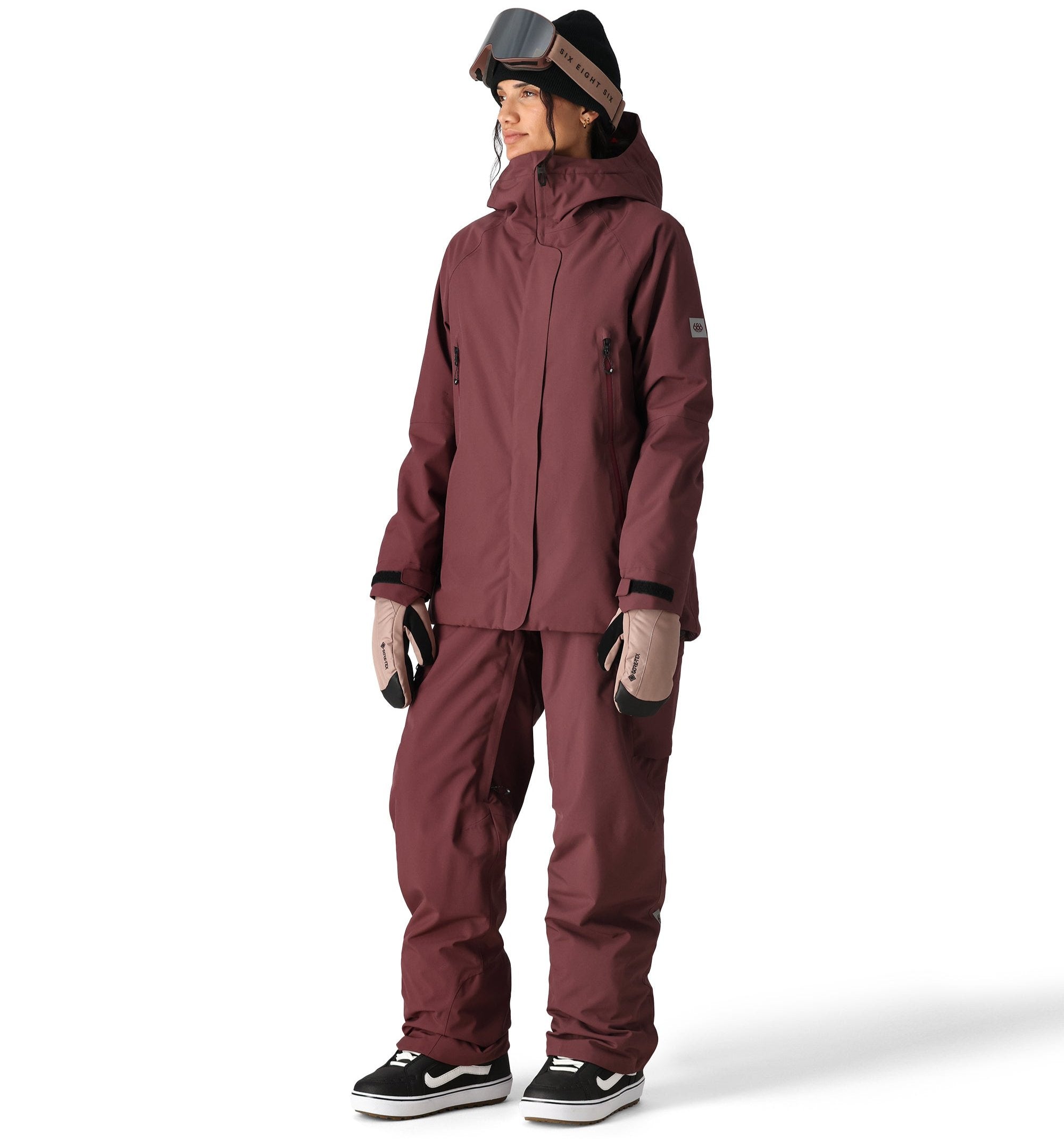 The 686 Whisper Insulated Jacket in mauve has a high collar and zippered pockets on either side.