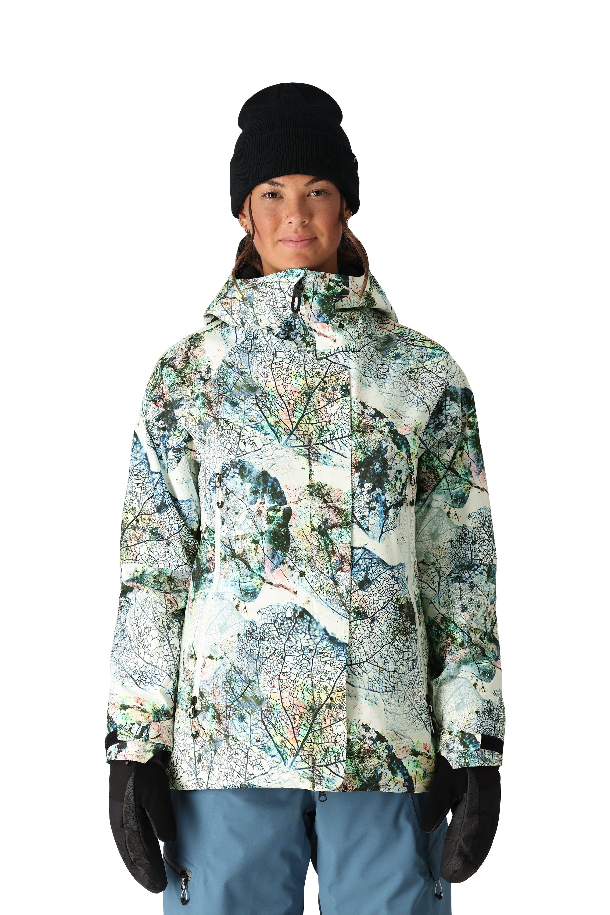 The 686 Women's Whisper Insulated Jacket 2025 has a white base with a multicolored abstract leaf pattern and a black zipper.