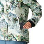 The 686 Women's Whisper Insulated Jacket features a white base with a colorful leaf pattern and has an insulated hood.