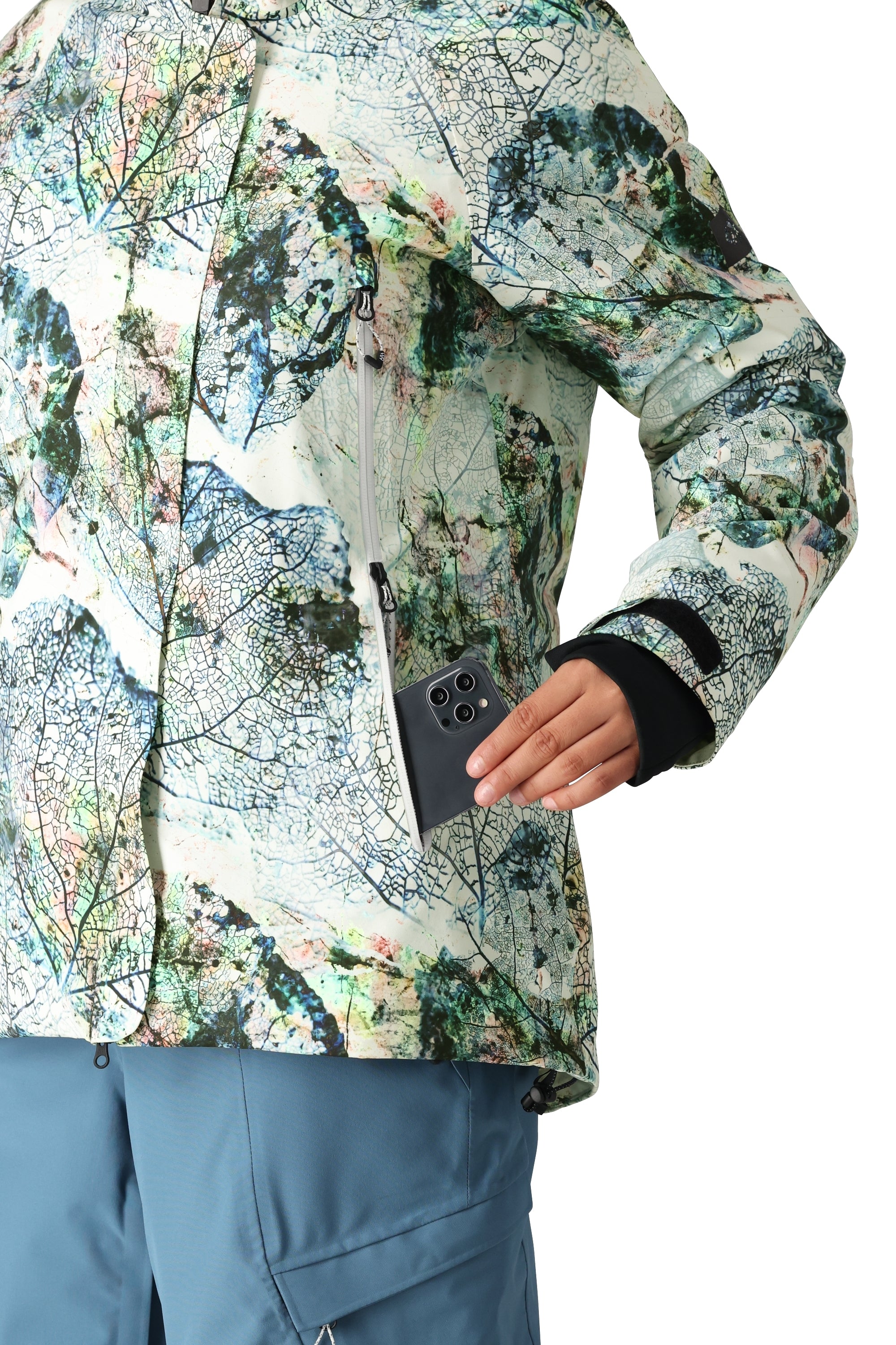 The 686 Women's Whisper Insulated Jacket features a white base with a colorful leaf pattern and has an insulated hood.