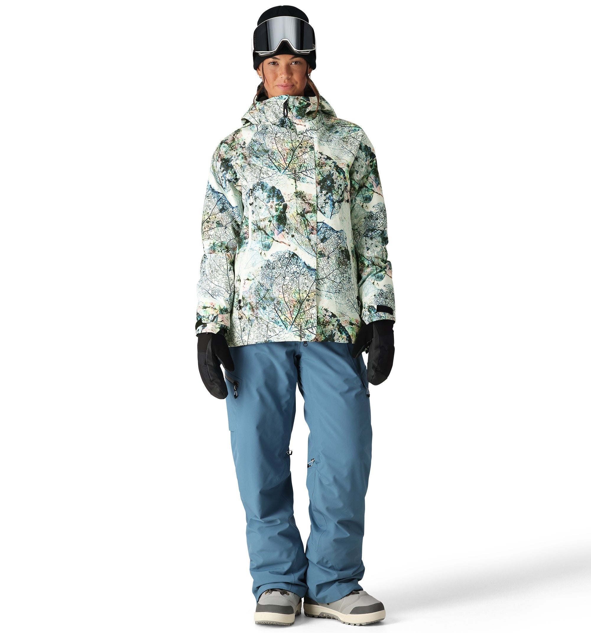 The 686 Whisper Insulated Jacket from 686 features a white base with green and blue floral patterns, a high collar, and an adjustable hood.