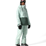 The 686 Harper shell bib, visible in front view, is mint green with a pattern of small red and black shapes.