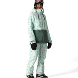 The 686 Harper shell bib, visible in front view, is mint green with a pattern of small red and black shapes.