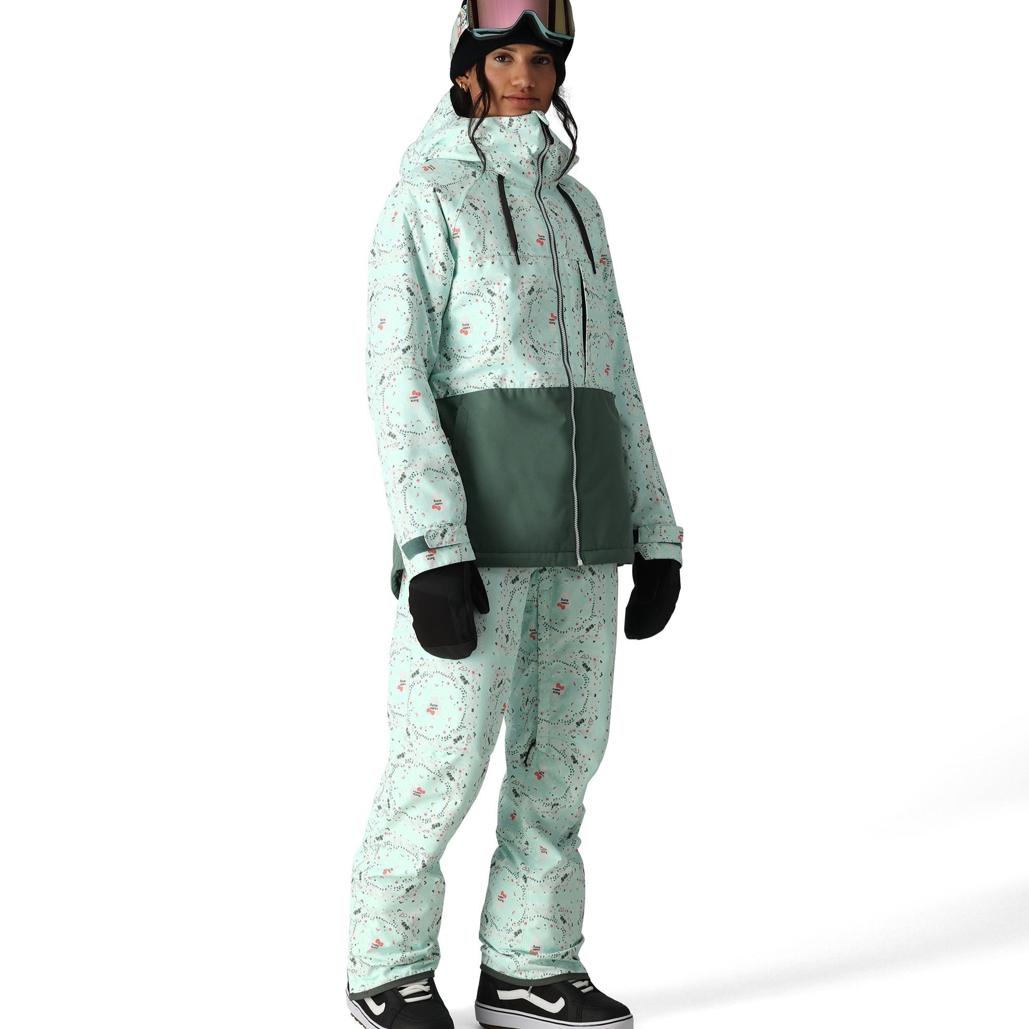 The 686 Harper shell bib, visible in front view, is mint green with a pattern of small red and black shapes.