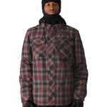 The 686 Woodland Insulated Jacket 2025, visible from the front view, has a red and black plaid pattern with an insulated hood.
