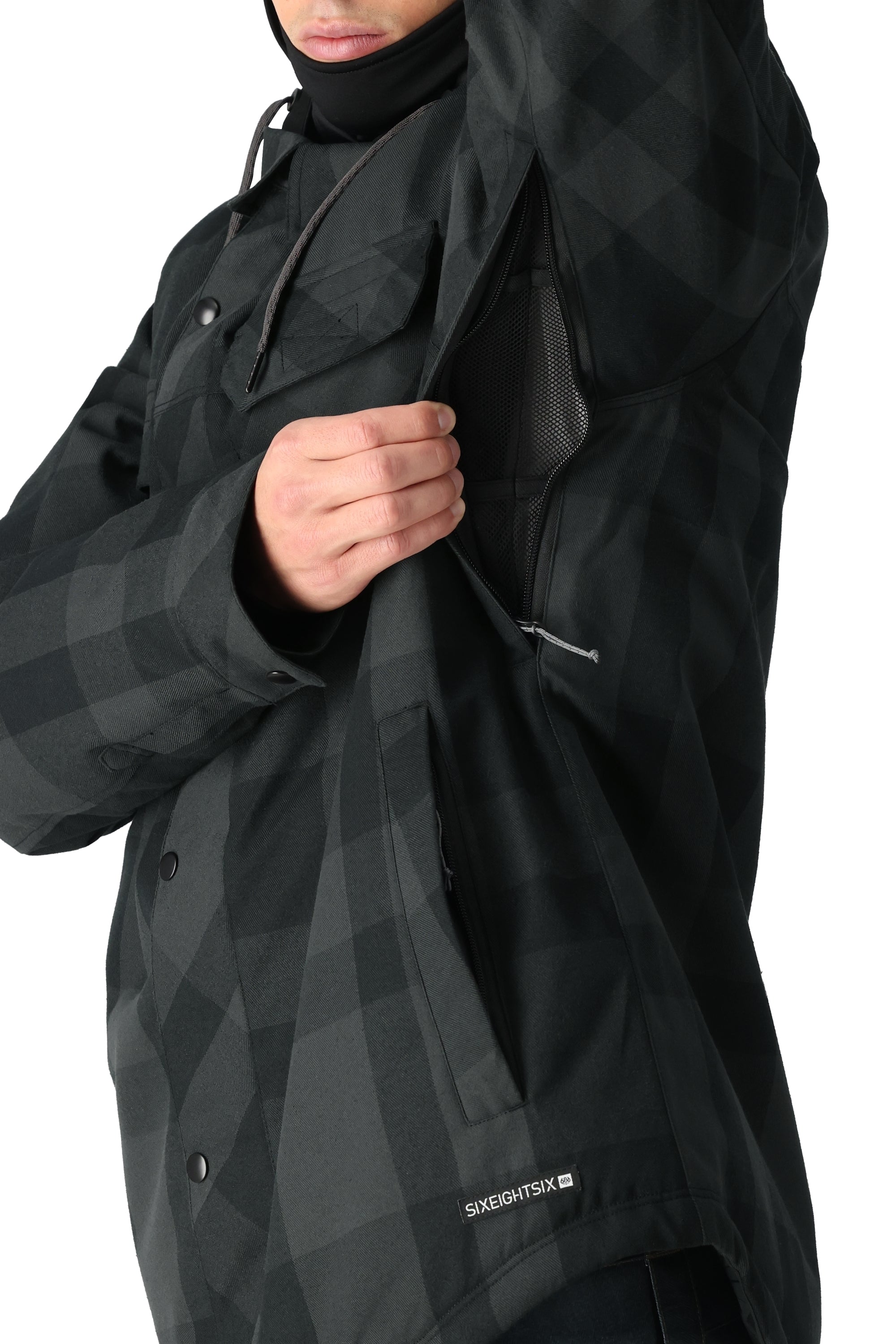 The 686 Woodland Insulated Jacket 2025 in black and gray plaid features an insulated hood.
