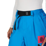 Women’s shell pant in bright blue with black belt, side pocket, and FOX logo patch