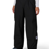 Women's black waterproof shell pants with elastic waistband and thigh logo patch