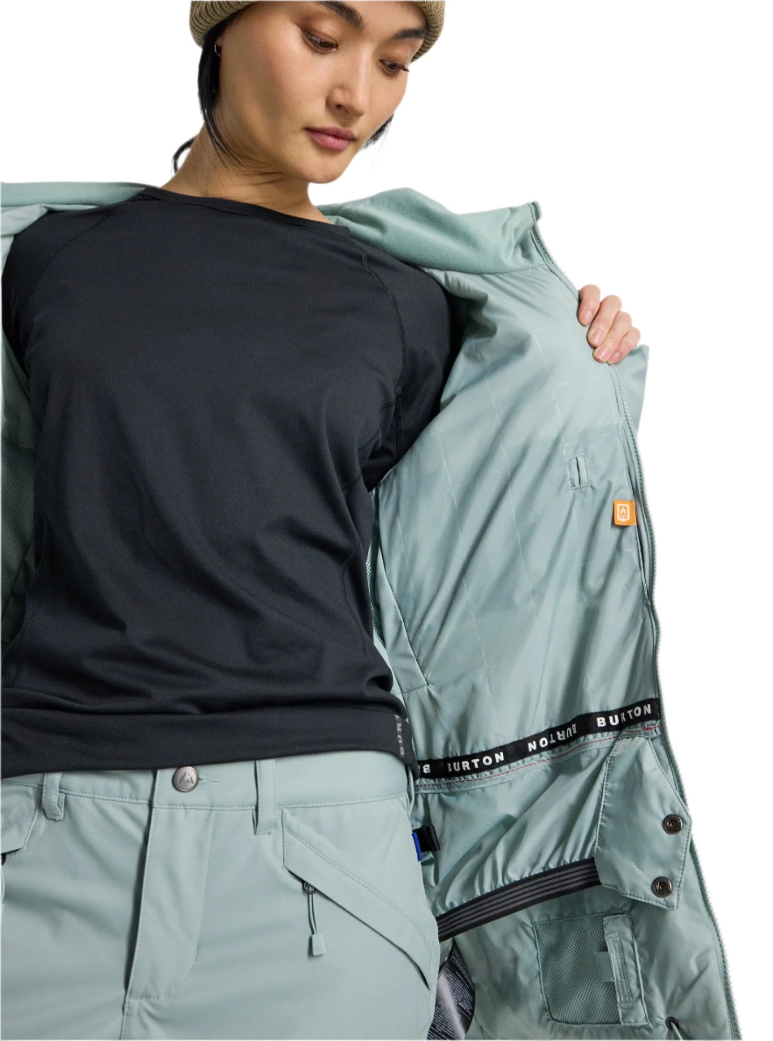 Burton Women's Lelah 2L Jacket 2025 - A light blue jacket with a hood, worn by a model who is facing away from the camera and looking down at her feet.