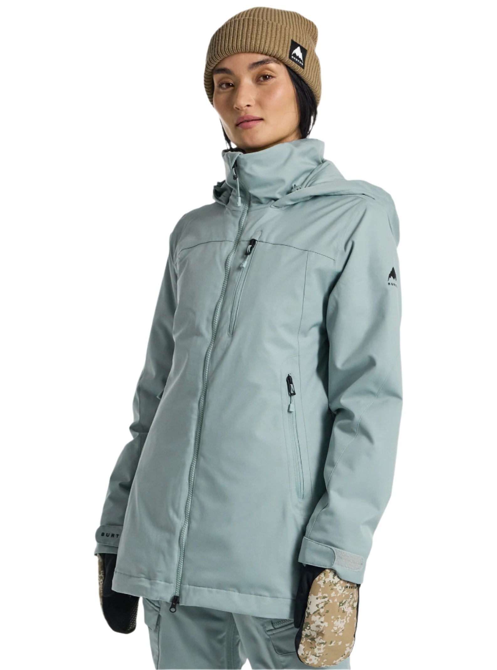 Burton Women's Lelah 2L Jacket 2025 - A light blue jacket with a high collar and zippered pockets, featuring a small black logo on the left sleeve.
