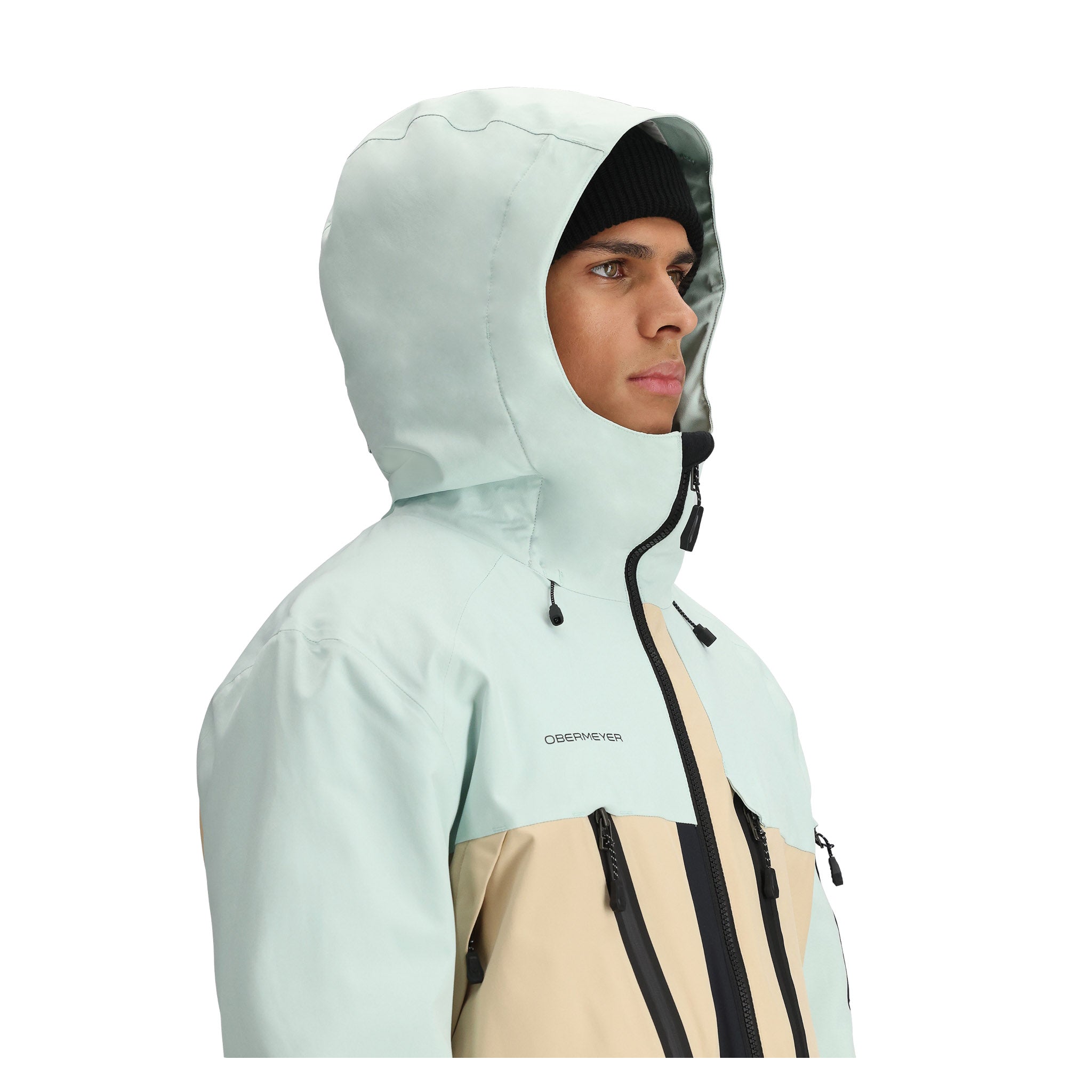 Obermeyer Cirque Jacket 2025 - A light blue jacket with a hood, featuring black zippers and a tan panel on the chest.