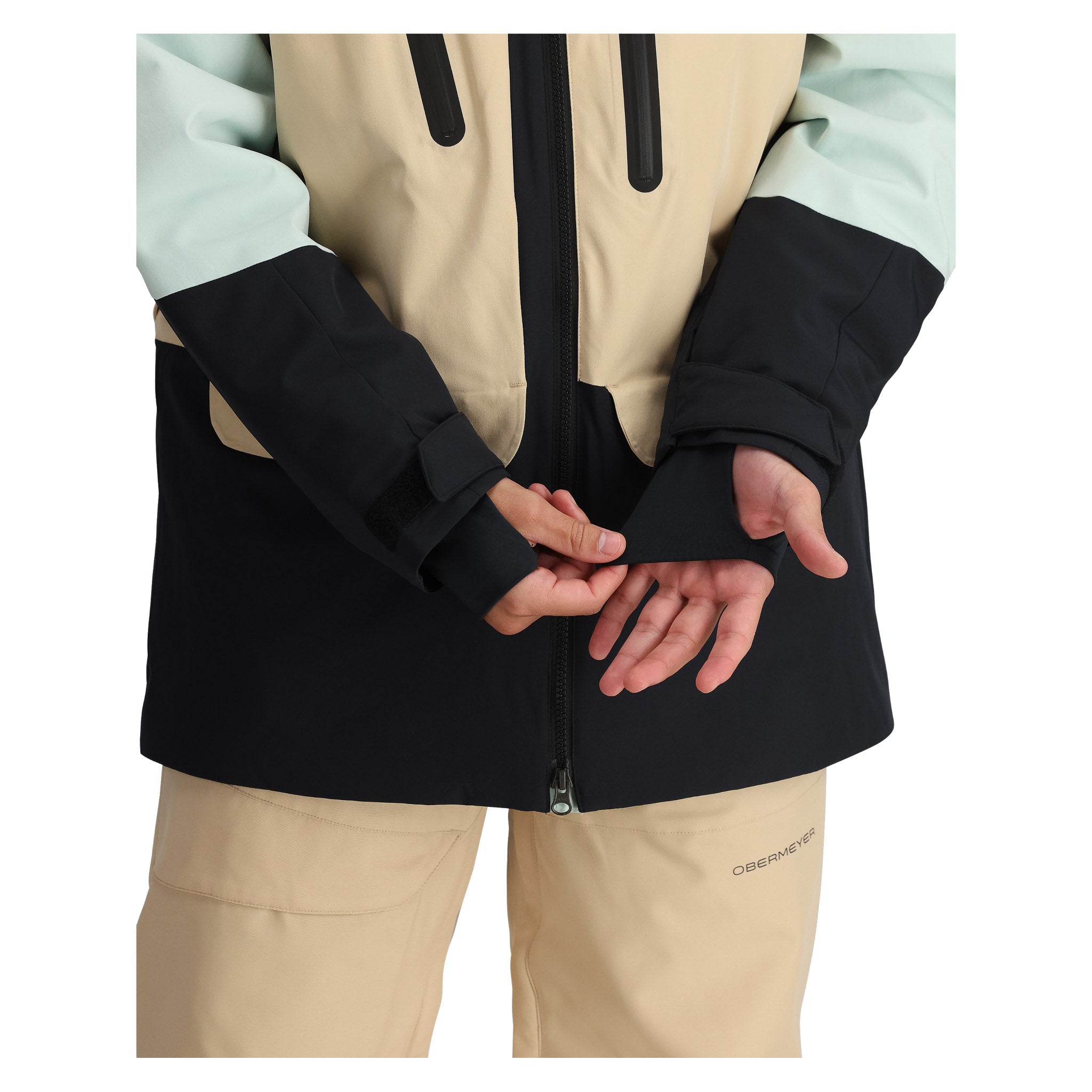 Obermeyer Cirque Jacket 2025 - A black, tan, and mint green jacket with a zipper down the front.