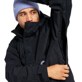 Burton Frostner 2L Anorak Jacket 2025 - A black jacket with a hood and zippered pockets, featuring a reflective logo on the left chest.