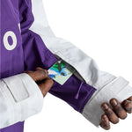 Burton Frostner 2L Anorak Jacket 2025 - A purple and white jacket with a large "O" on the left side, featuring a zippered pocket with a colorful design.