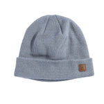 Coal Harbor Rib Knit Beanie 2025 - A light gray beanie with a ribbed texture and a small brown leather patch on the front that says "COAL" in black letters.