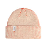 Pink knit beanie with a Coal brand label on a light gray background