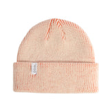 Pink knit beanie with a Coal brand label on a light gray background